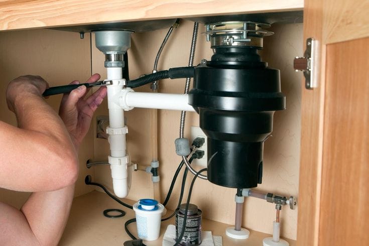 Plumber repairing a garbage disposal in Palo Alto