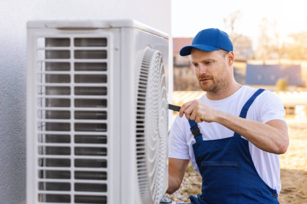 HVAC technician servicing an outdoor air conditioner in Palo Alto